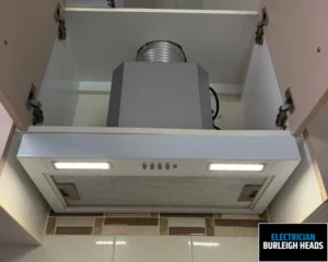 Close-up view of a ceiling-mounted air conditioning vent with ductwork visible.